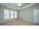 Bedroom boasts trey ceiling, carpet, and multiple windows with blinds at 303 Sand Dune Trl, Summerville, SC 29486