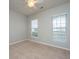 Cozy bedroom with neutral walls, carpet, and natural light streaming through two large windows at 303 Sand Dune Trl, Summerville, SC 29486