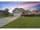 Charming single-Gathering home with a well-manicured lawn, mature tree, and covered front porch at 303 Sand Dune Trl, Summerville, SC 29486