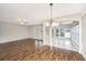 Bright, open living room features hardwood floors, multiple windows, and contemporary lighting at 303 Sand Dune Trl, Summerville, SC 29486