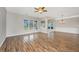 Bright, open living room features hardwood floors, multiple windows, and contemporary lighting at 303 Sand Dune Trl, Summerville, SC 29486