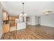 Open-concept living area with hardwood floors seamlessly connects to the modern kitchen at 303 Sand Dune Trl, Summerville, SC 29486