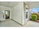 Charming front porch of gray home, with a gray door and ample windows, on a concrete slab at 303 Sand Dune Trl, Summerville, SC 29486