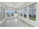 Bright sunroom filled with natural light, tile floors, and many windows with backyard views at 303 Sand Dune Trl, Summerville, SC 29486