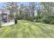 Expansive backyard with a well-maintained lawn, patio space, grill and bench at 3109 Hugh Bennett Dr, Johns Island, SC 29455