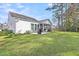 Spacious backyard with a well-maintained lawn, patio, grill, mature trees and screened in porch at 3109 Hugh Bennett Dr, Johns Island, SC 29455