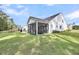 Wide-open backyard featuring a screened-in patio and a green lawn at 3109 Hugh Bennett Dr, Johns Island, SC 29455