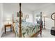 Bedroom featuring a four-poster bed, hardwood furnishings, and natural light at 3109 Hugh Bennett Dr, Johns Island, SC 29455