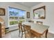 Bright dining room featuring a large window and natural wood table set at 3109 Hugh Bennett Dr, Johns Island, SC 29455
