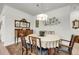 Traditional dining room with wooden table, upholstered chairs, and china cabinet with ornate mirror at 3109 Hugh Bennett Dr, Johns Island, SC 29455