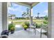 Inviting covered front porch adorned with two chairs, plants and a view of the outdoors at 3109 Hugh Bennett Dr, Johns Island, SC 29455