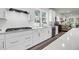 Well-lit kitchen features white cabinets, stainless appliances, and a view of the backyard at 3109 Hugh Bennett Dr, Johns Island, SC 29455