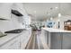 Open concept kitchen with white cabinets, gray island, and sightlines to the living room at 3109 Hugh Bennett Dr, Johns Island, SC 29455