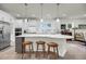 Bright kitchen features white cabinets, stainless appliances, and a spacious island with seating at 3109 Hugh Bennett Dr, Johns Island, SC 29455