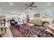 Bright living room featuring plush seating, large windows, modern ceiling fan and an open kitchen at 3109 Hugh Bennett Dr, Johns Island, SC 29455