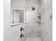Close-up of shower with marble-look tiles, rainfall showerhead, and glass door at 3109 Hugh Bennett Dr, Johns Island, SC 29455