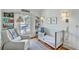 Bright Bedroom featuring a crib, chair, hardwood floors, natural light, and built-in bookshelves at 312 President St, Charleston, SC 29403