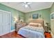 Comfortable green-painted bedroom with hardwood floors, dresser, and king-size bed at 312 President St, Charleston, SC 29403