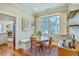 Cozy dining nook with hardwood floors, window seating, and quaint wooden table with chairs at 312 President St, Charleston, SC 29403