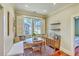 Charming dining nook with a cozy banquette, ample natural light, and a view of the neighborhood at 312 President St, Charleston, SC 29403