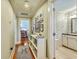 Hallway with wood flooring, neutral walls, and decorated with pictures and small white bookshelf at 312 President St, Charleston, SC 29403