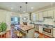 Bright kitchen features center island with wood countertop, stainless steel appliances, and hardwood floors at 312 President St, Charleston, SC 29403