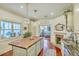 Bright and airy kitchen featuring a large butcher block island, granite countertops, and a cozy fireplace at 312 President St, Charleston, SC 29403