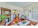 Elegant living room featuring a fireplace, hardwood floors, and shuttered windows, creating a cozy atmosphere at 312 President St, Charleston, SC 29403