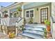 Inviting porch with comfortable seating, hanging plants, and charming decor, perfect for relaxing at 312 President St, Charleston, SC 29403