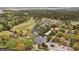 An aerial shot showcasing the golf course and residential neighborhood, surrounded by lush trees at 3125 Sturbridge Rd, Mount Pleasant, SC 29466