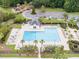 Aerial view of the community pool with a play area, loungers, and palm trees at 3125 Sturbridge Rd, Mount Pleasant, SC 29466