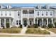 Charming townhouse with double porch, white railings, and beautiful landscaping at 3125 Sturbridge Rd, Mount Pleasant, SC 29466