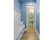 Hallway with bench seating, coat rack, and doorway leading to a well-lit half bathroom at 3125 Sturbridge Rd, Mount Pleasant, SC 29466