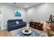 Cozy living room with blue sofa, glass coffee table, and stylish decor, creating an inviting atmosphere at 3125 Sturbridge Rd, Mount Pleasant, SC 29466