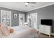 Inviting main bedroom with white bedding, gray walls, and a glimpse into a serene bathroom suite at 3125 Sturbridge Rd, Mount Pleasant, SC 29466