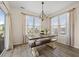 Bright dining room features a wooden table with bench seating and a stylish chandelier at 324 Saucer Rd, Summerville, SC 29486