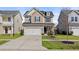 Two-story home with a two-car garage, dark shutters, and landscaping in the front yard at 324 Saucer Rd, Summerville, SC 29486