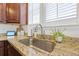 Close-up view of the stainless steel sink, granite countertops and window with blinds at 324 Saucer Rd, Summerville, SC 29486