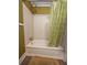 Bathroom with a standard bathtub, shower, and a green patterned shower curtain at 3695 Cannon Rd, Round O, SC 29474