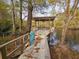 Dock with wood railing and blue accent over the water, perfect for relaxation at 3695 Cannon Rd, Round O, SC 29474