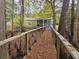 Wooden walkway leading to a home, offering a unique access and a glimpse of the property at 3695 Cannon Rd, Round O, SC 29474