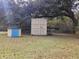 Spacious backyard featuring outbuildings nestled under a large tree canopy at 3695 Cannon Rd, Round O, SC 29474