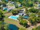 Aerial view of community pool, tennis courts, and playground surrounded by lush greenery and well-maintained homes at 4045 Oxeye Loop, Johns Island, SC 29455