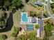 Overhead aerial view of community amenities featuring a pool, tennis courts, playground, and parking at 4045 Oxeye Loop, Johns Island, SC 29455