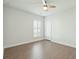 A bright, naturally lit bedroom featuring a ceiling fan, hardwood floors, a large window, and a closet at 4045 Oxeye Loop, Johns Island, SC 29455