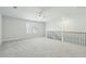 A spacious, naturally-lit bonus room with carpet floors, a metal railing, and a large window with plantation shutters at 4045 Oxeye Loop, Johns Island, SC 29455