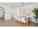 Elegant dining room with a modern chandelier, seating for four, and natural light at 4045 Oxeye Loop, Johns Island, SC 29455