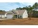 Angle view of a single-Gathering home featuring a two-car garage and gray siding in a well-maintained front yard at 4045 Oxeye Loop, Johns Island, SC 29455