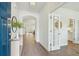 Bright foyer with hardwood floors, archway, and glass-paned door providing a view into a dining or living room at 4045 Oxeye Loop, Johns Island, SC 29455