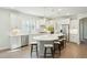 Modern, stylish kitchen with white cabinets, stainless appliances, unique island with seating, and wood flooring at 4045 Oxeye Loop, Johns Island, SC 29455